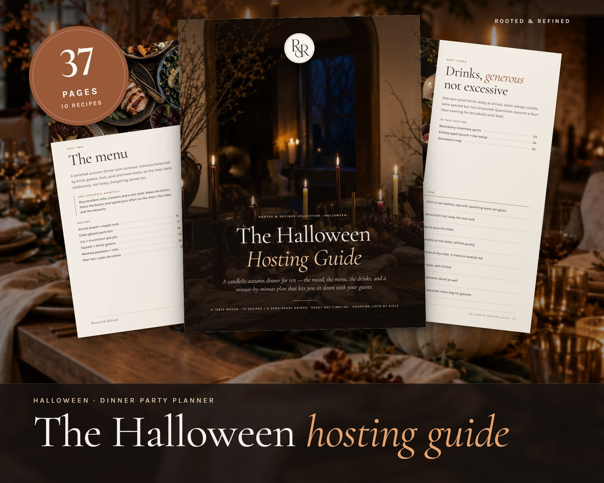 The Halloween Hosting Guide printable from Rooted & Refined: cover preview with the printed pages styled on a table