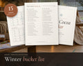 Winter Bucket List printable from Rooted & Refined: cover preview with the printed pages styled on a table