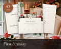 First Birthday Party Kit printable from Rooted & Refined: cover preview with the printed pages styled on a table