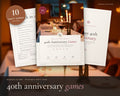 40th Anniversary Party Games printable from Rooted & Refined: cover preview with the printed pages styled on a table