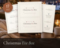 Christmas Eve Box Printables printable from Rooted & Refined: cover preview with the printed pages styled on a table