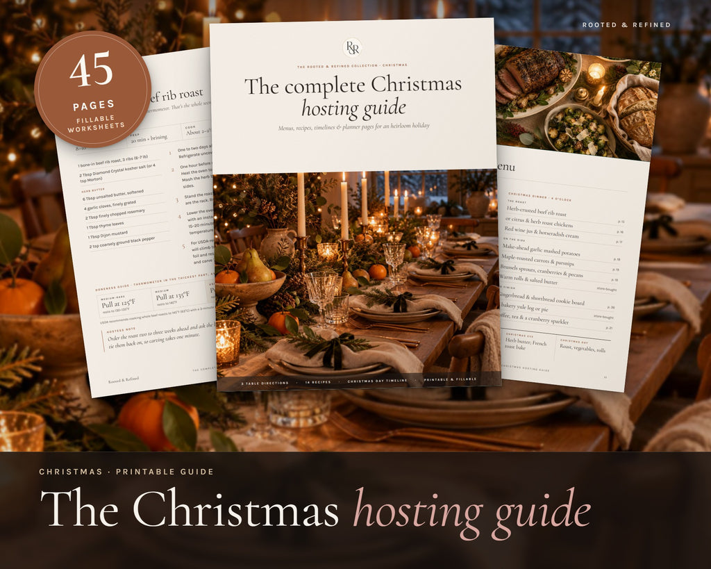 The Complete Christmas Hosting Guide printable from Rooted & Refined: cover preview with the printed pages styled on a table