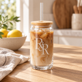 R&R monogram engraved glass cup with bamboo lid with iced coffee in a bright kitchen