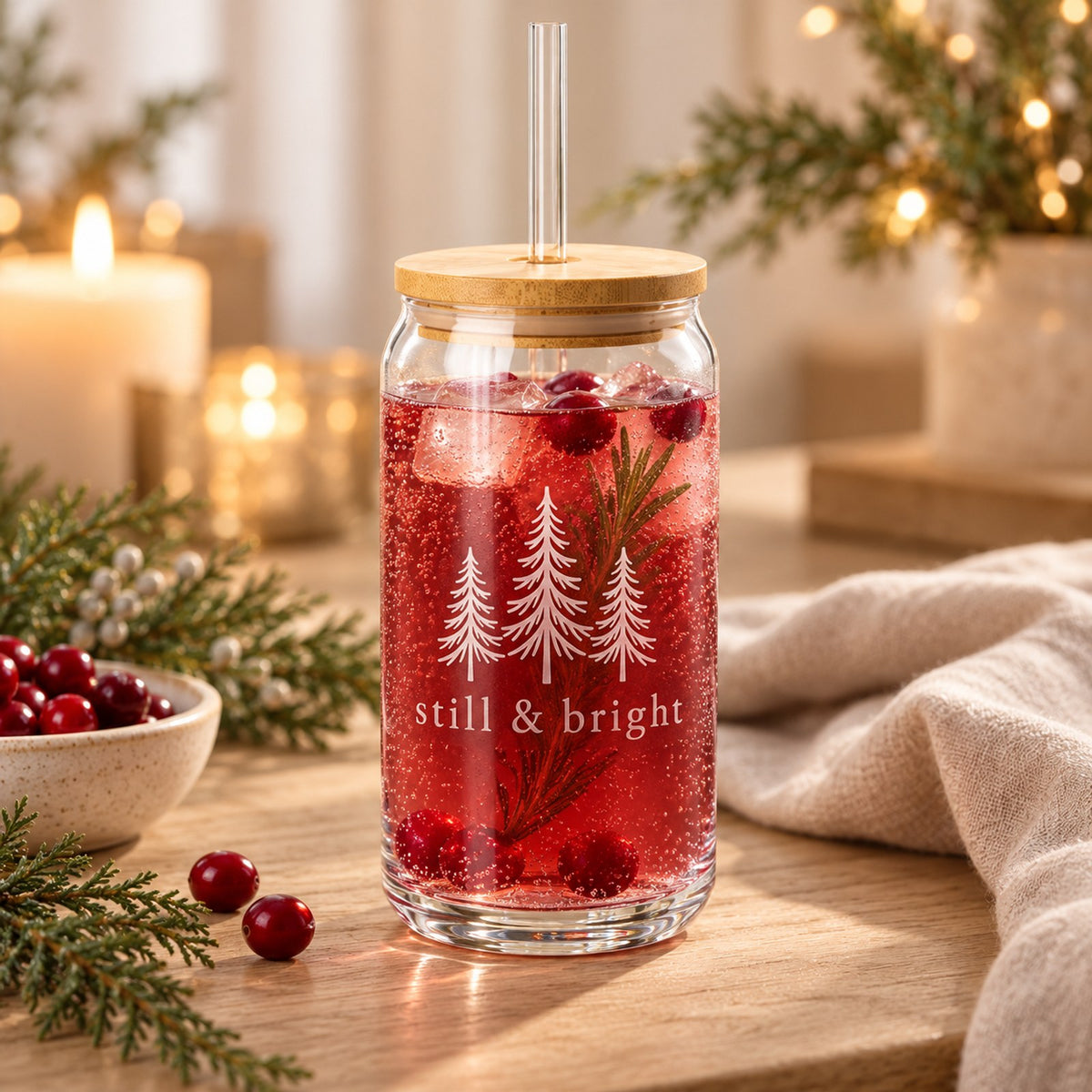 Still & bright evergreen engraved glass cup with bamboo lid with a cranberry drink and evergreen