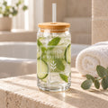 Rooted & Refined signature label engraved glass cup with bamboo lid filled with cucumber water