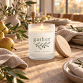 Gather olive sprig frosted glass candle lit on a linen-lined harvest table
