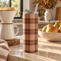 Rust and camel buffalo check tumbler on a kitchen counter with a pour-over coffee set and a bowl of pears