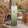 Sage ombré tumbler with a small sprig on a rustic potting bench with terracotta pots and dried flowers