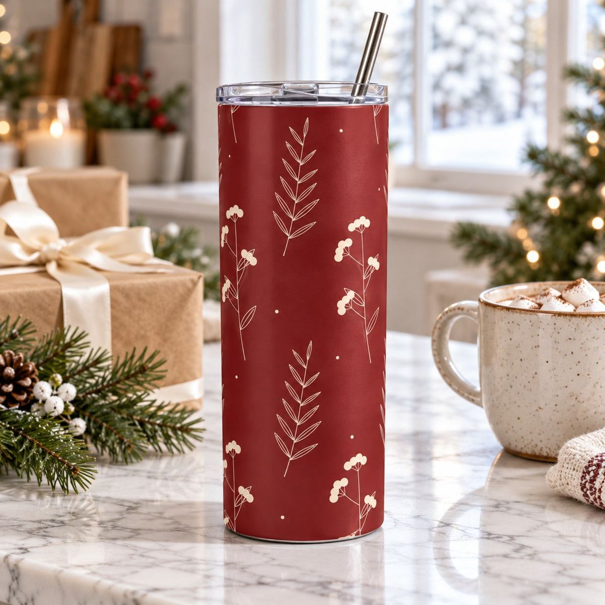Cranberry winter berry tumbler on a marble counter with wrapped gifts, pine and a mug of cocoa