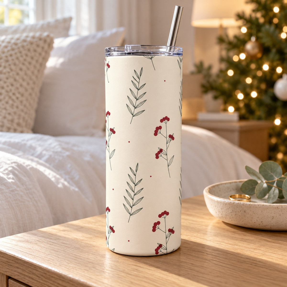 Linen winter berry tumbler with red berries and sage sprigs on a bedside table in a soft white bedroom