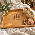 Bamboo serving tray engraved with evergreens and still & bright, with coffee and cinnamon rolls on a cozy bed