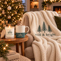 Still & Bright Evergreen Cozy Night In Gift Set by Rooted & Refined: matching sherpa throw draped on a chair with the lit frosted candle and engraved mug beside it