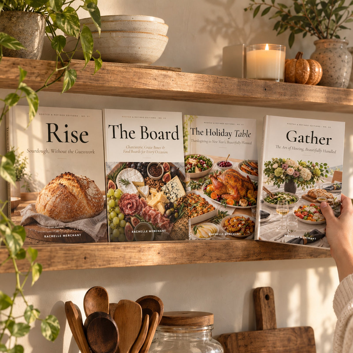 The Rooted & Refined Editions — Hardcover Collection: Rise, The Board, The Holiday Table and Gather by Rachelle Merchant on a kitchen shelf