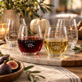 Gather Engraved Wine Glass Set of 4 by Rooted & Refined: four etched stemless glasses styled together