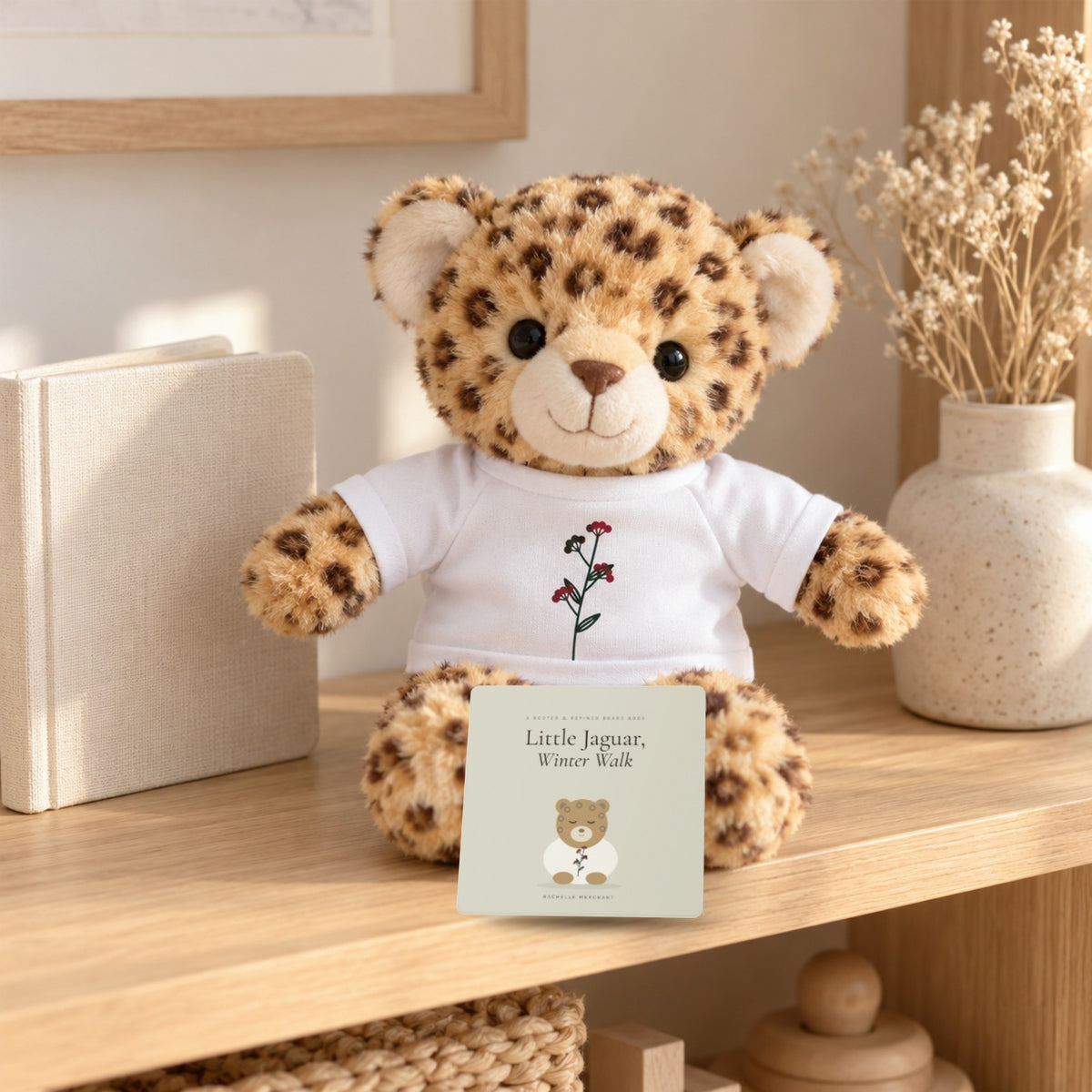 Little Jaguar Book & Plush Gift Set by Rooted & Refined: the Little Jaguar, Winter Walk board book with the Little Jaguar plush on a nursery shelf