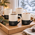 Snowflake Engraved Mug Set of 4 by Rooted & Refined: four black speckled mugs styled together