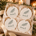 Noel Pine Branch Ornament Set of 4 by Rooted & Refined: four round ceramic ornaments styled together