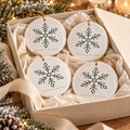 Snowflake Ornament Set of 4 by Rooted & Refined: four round ceramic ornaments styled together