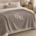 R&R Monogram Sherpa Fleece Blanket in Warm Grey, styled at home