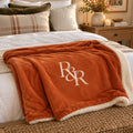 R&R Monogram Sherpa Fleece Blanket in Burnt Orange, styled at home