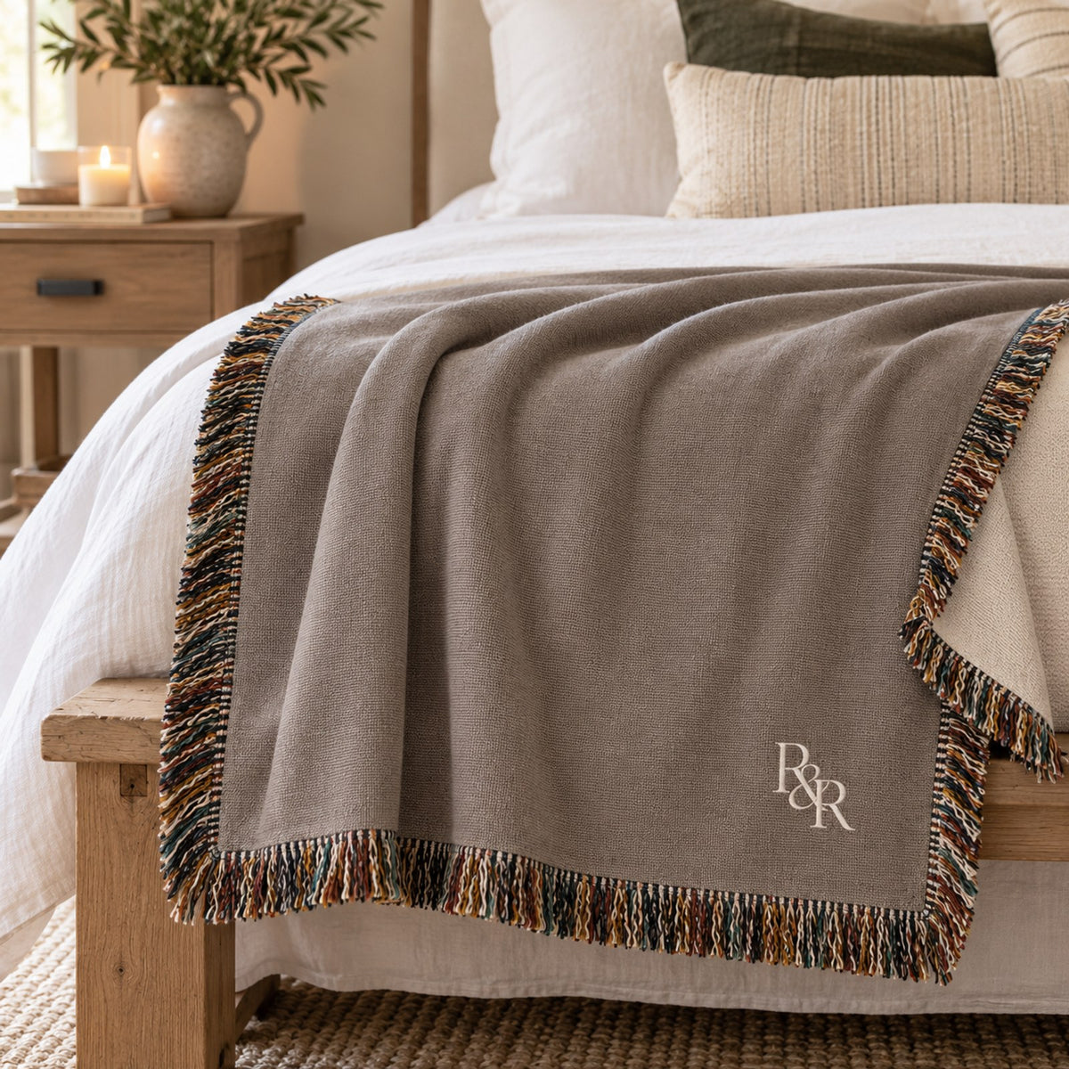 Small R&R Monogram Woven Throw Blanket in Warm Grey, styled at home