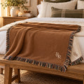 Small R&R Monogram Woven Throw Blanket in Toffee, styled at home