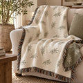 Olive branch woven throw with a colourful fringe