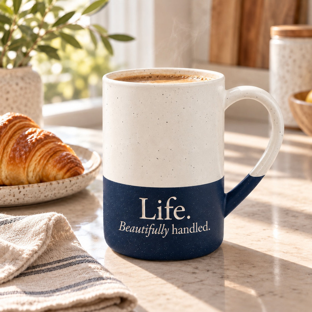 Life. Beautifully Handled. engraved speckled mug in Navy Blue on a morning kitchen counter