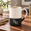 R&R monogram engraved speckled mug in Black on a walnut desk