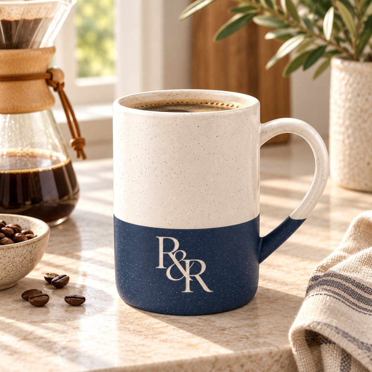 R&R monogram engraved speckled mug in Navy Blue on a kitchen counter with pour-over coffee