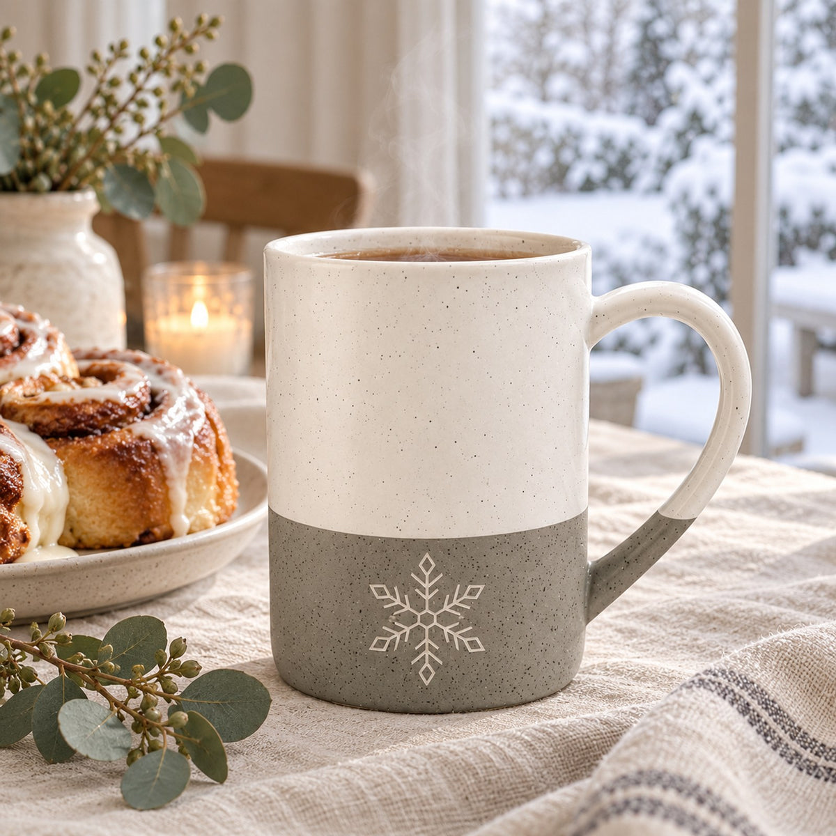 Snowflake engraved speckled mug in Grey on a winter breakfast table