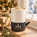 Still & Bright evergreen engraved speckled mug in Black by a Christmas window