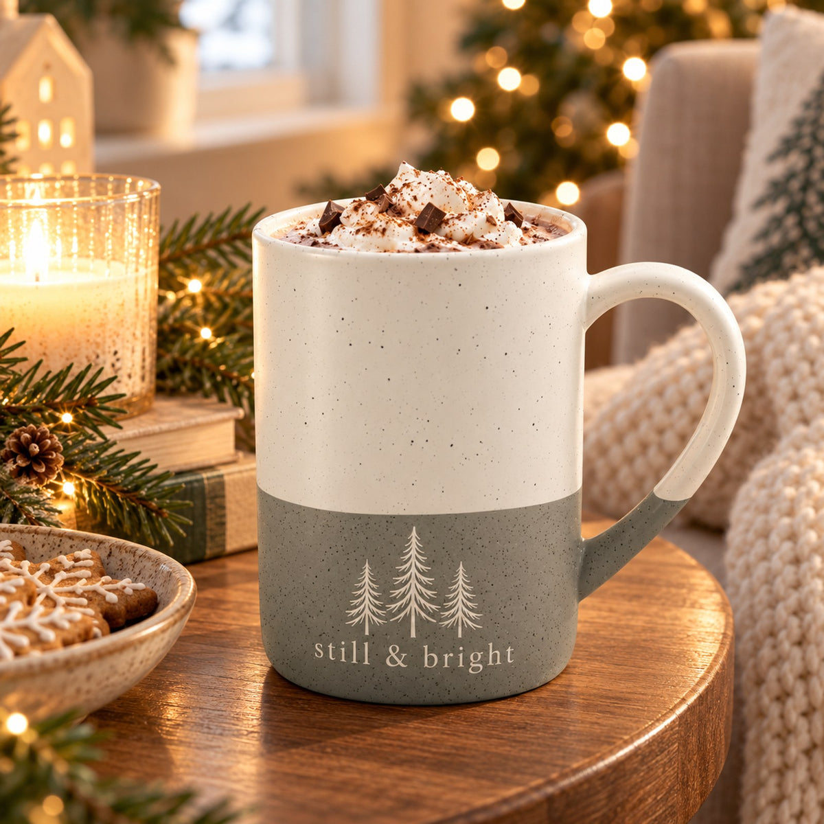 Still & Bright evergreen engraved speckled mug in Grey in a cosy Christmas reading nook