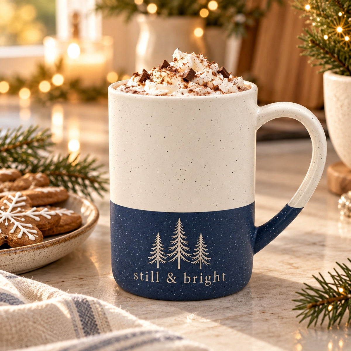 Still & Bright evergreen engraved speckled mug in Navy Blue on a festive kitchen counter