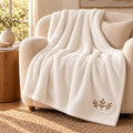 Autumn Sprig Embroidered Plush Throw in Marshmallow, styled at home