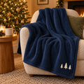 Cream Pine Trio Embroidered Plush Throw in Navy, styled at home