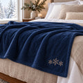 Snowflake Trio Embroidered Plush Throw in Navy, styled at home