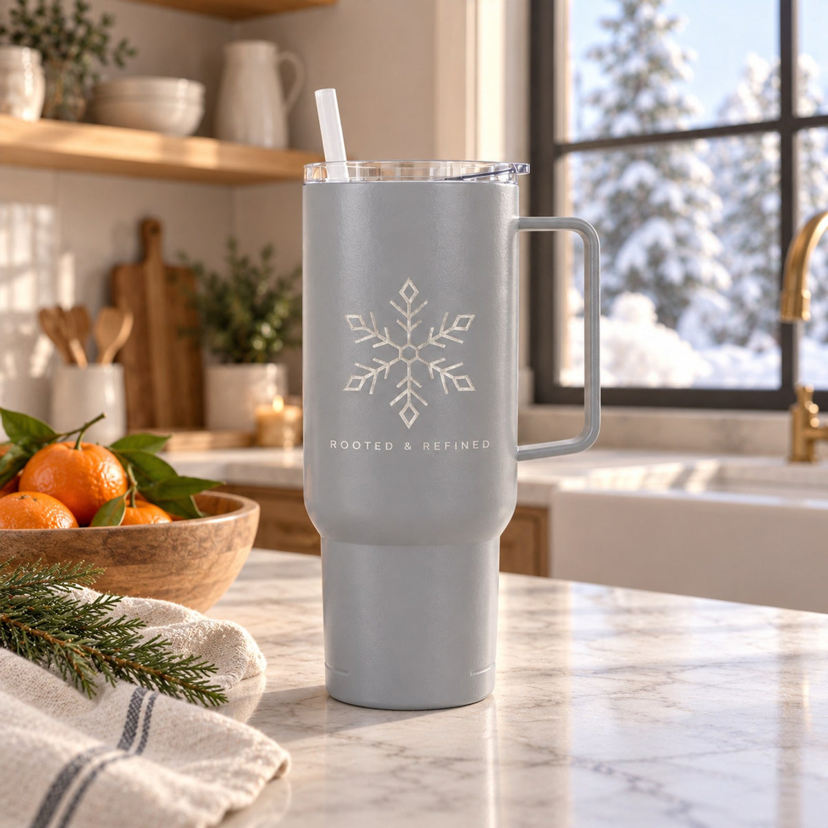 Gray 40 oz tumbler with handle engraved with a snowflake