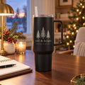Black 40 oz tumbler with handle engraved with three evergreen trees and still & bright