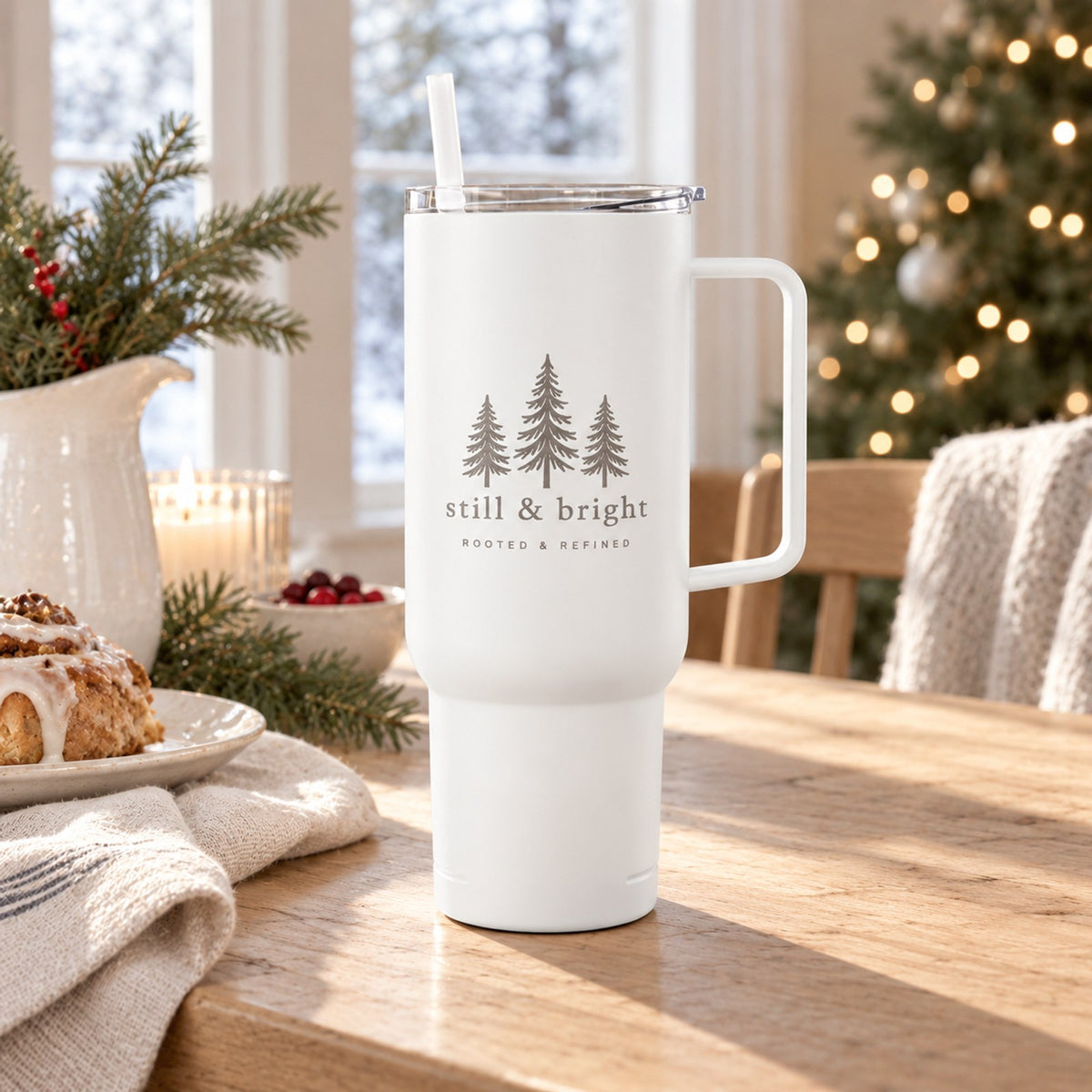White 40 oz tumbler with handle engraved with three evergreen trees and still & bright