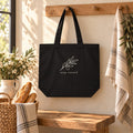 Stay Rooted Olive Branch Organic Cotton Tote in Black, styled at home