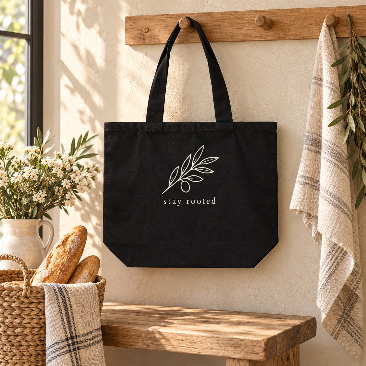 Stay Rooted Olive Branch Shoulder Tote in Black, styled at home